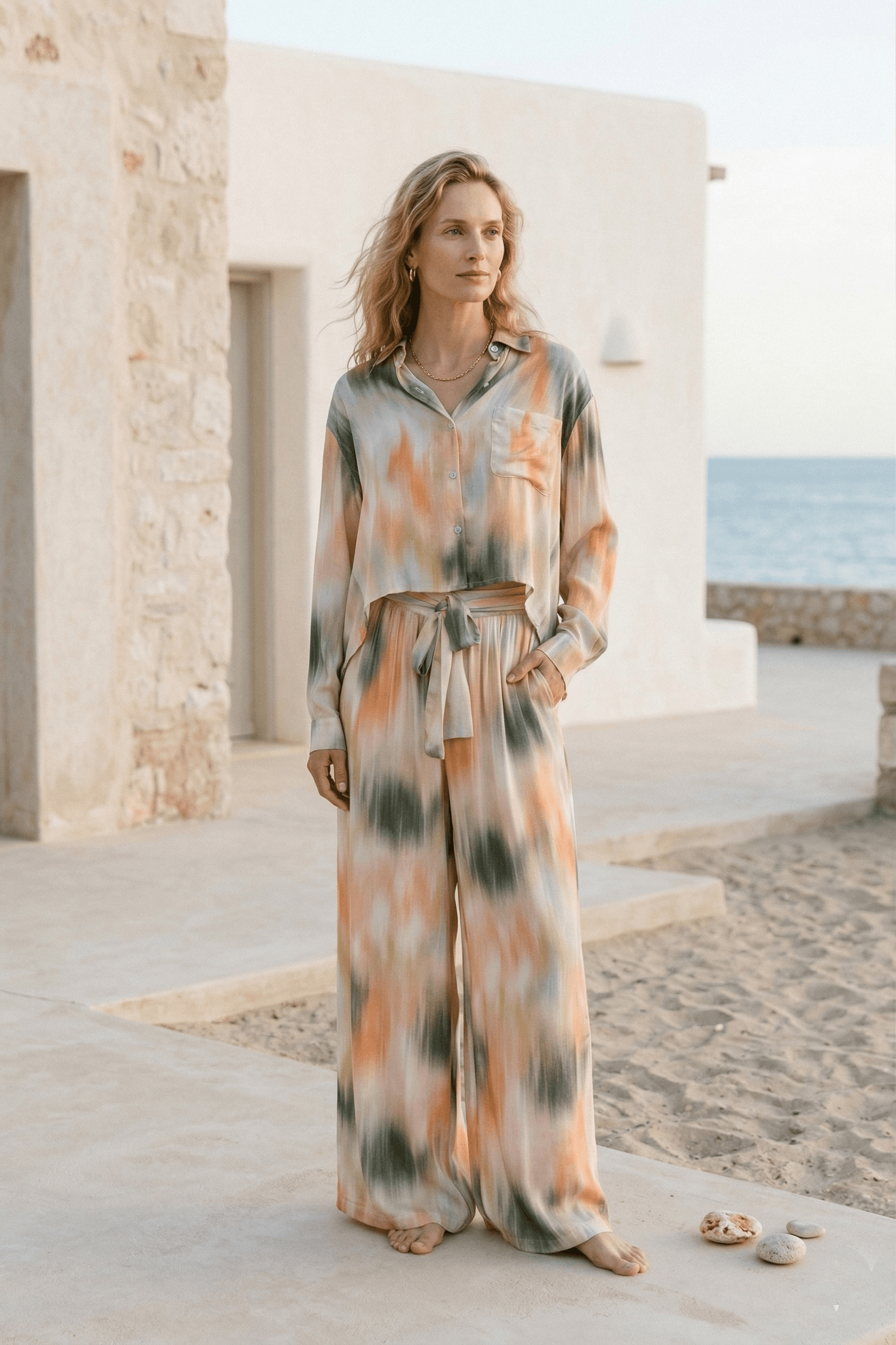 Model wearing Printed Cropped Ecovero Viscose Oversized Shirt with tie detail in a breezy beach setting.