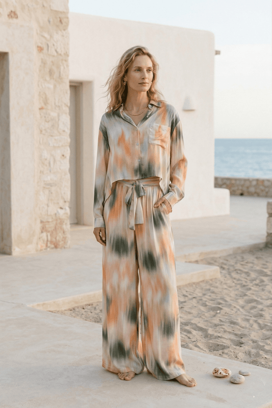 Model wearing Printed Cropped Ecovero Viscose Oversized Shirt with tie detail in a breezy beach setting.