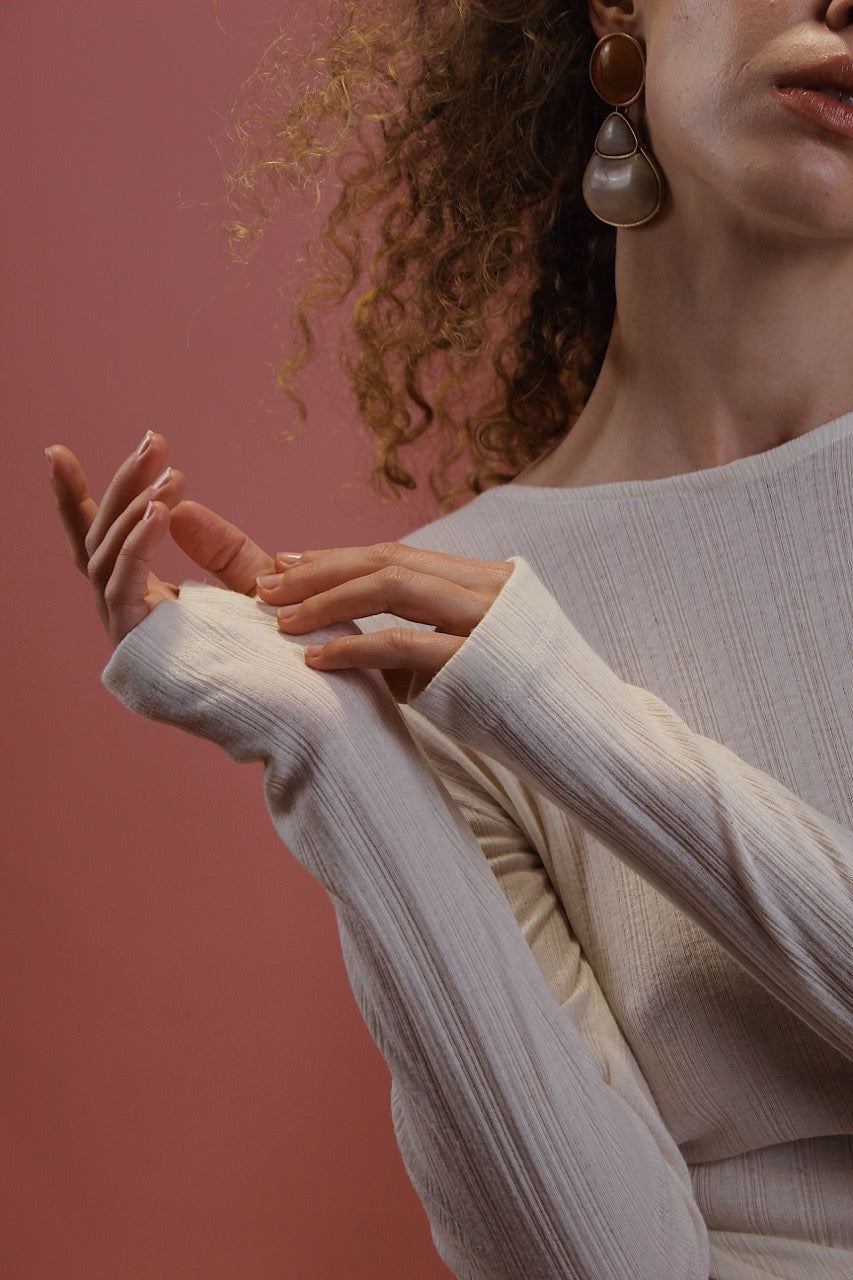 Banana Pineapple Multiway Wrap Top in Ecru worn by a model, showcasing the long sleeves and thumb hole detailing.