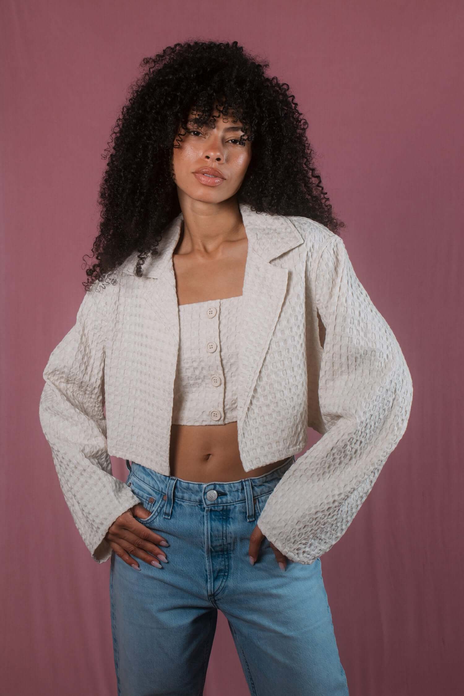 ECRU WAFFLE CROP JACKET displayed on model, featuring lightweight textured fabric and stylish cropped design.