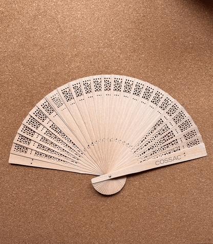 Wooden fan made from recycled wood, 30x30cm, featuring intricate cutouts and 'COSSAC' logo.
