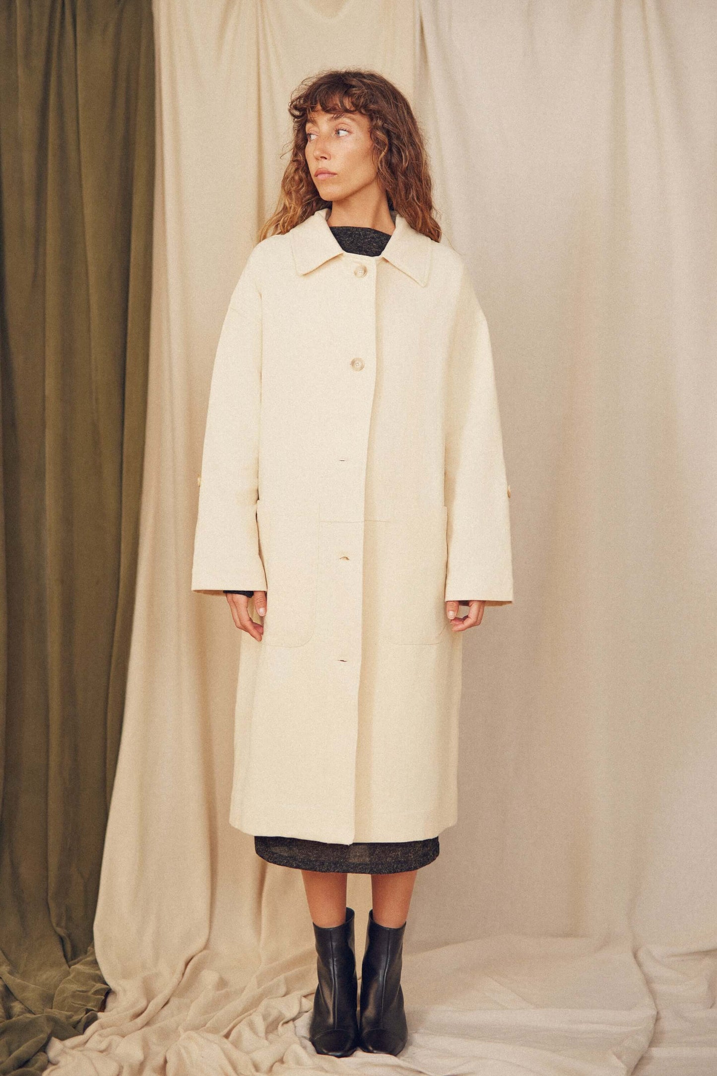 Model wearing Oat Organic Cotton Long Wide Coat against a neutral backdrop, showcasing its oversized silhouette.