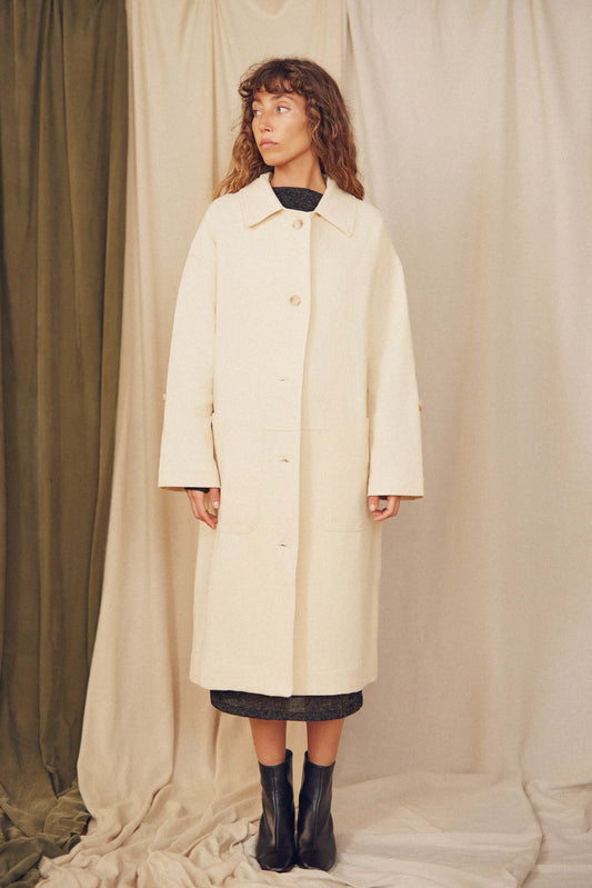 Model wearing Oat Organic Cotton Long Wide Coat against a neutral backdrop, showcasing its oversized silhouette.