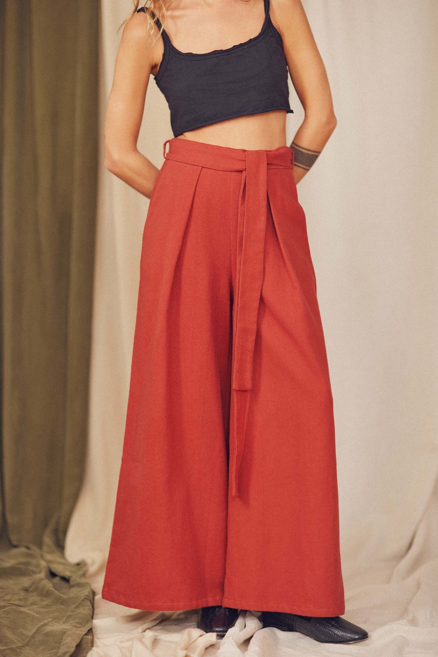 Rust Organic Cotton Wide Trousers featuring a detachable belt and voluminous silhouette, styled with a cropped top.