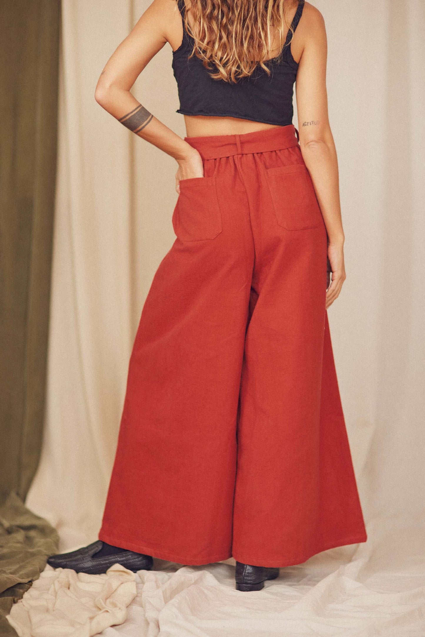 Rust Organic Cotton Wide Trousers featuring a voluminous silhouette and a detachable belt, styled with a cropped top.