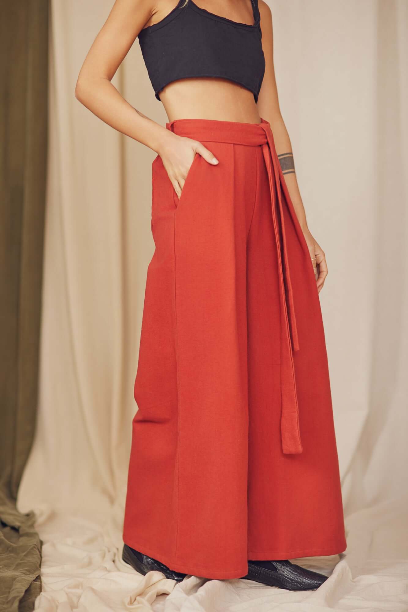 Rust Organic Cotton Wide Trousers with a detachable belt displayed on a model, highlighting their voluminous silhouette.