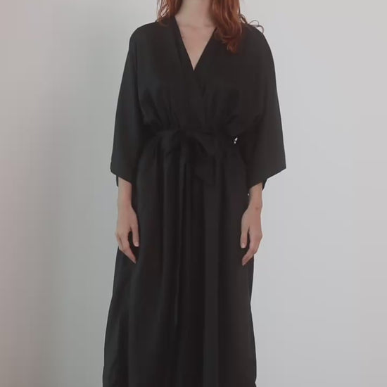 Tencel Kimono Jumpsuit in Black, featuring a relaxed silhouette with a belt and culotte-style trousers, perfect for warm weather.