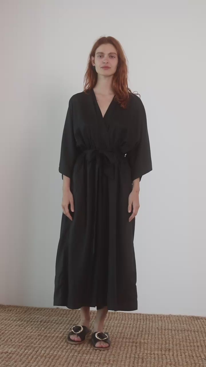 Tencel Kimono Jumpsuit in Black, featuring a relaxed silhouette with a belt and culotte-style trousers, perfect for warm weather.