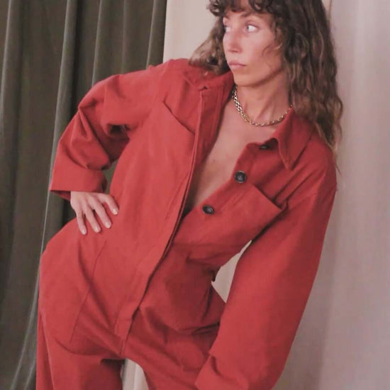 Model wearing a Rust Organic Cotton Boiler Suit, showcasing its stylish design and eco-friendly materials.