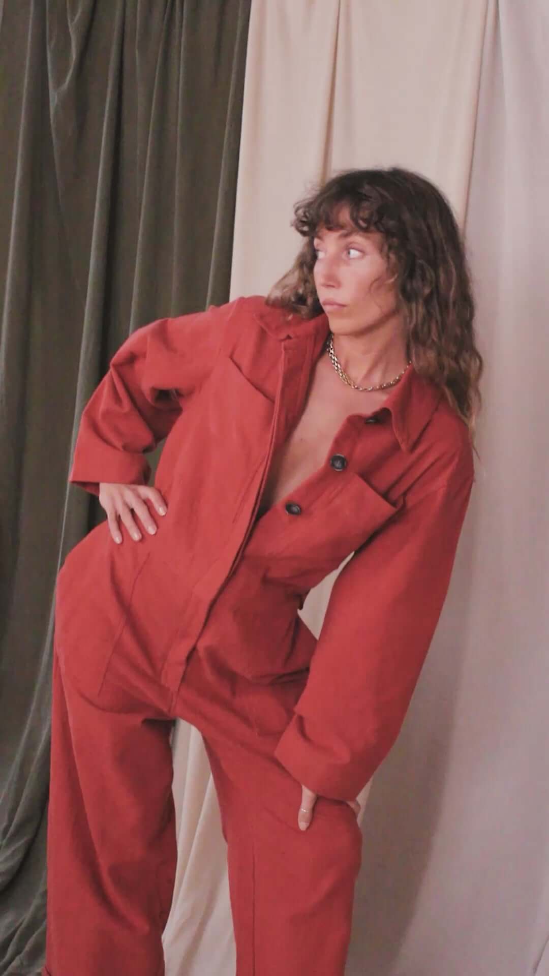 Model wearing a Rust Organic Cotton Boiler Suit, showcasing its stylish design and eco-friendly materials.