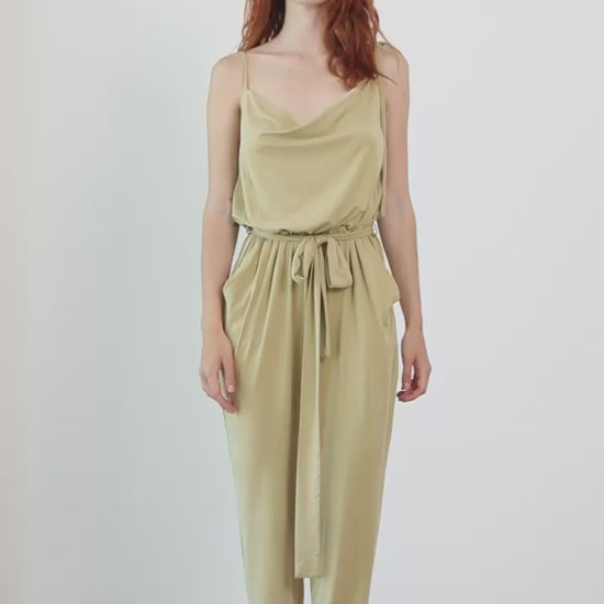 Cupro Slip Jumpsuit with Belt in Olive worn by a model, showcasing its modern and elegant design.