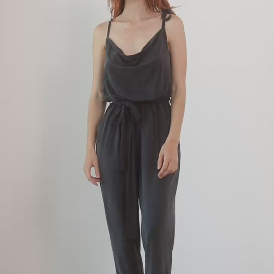 Cupro Slip Jumpsuit with Belt in Slate Black worn by model, showcasing relaxed elegance and versatility.