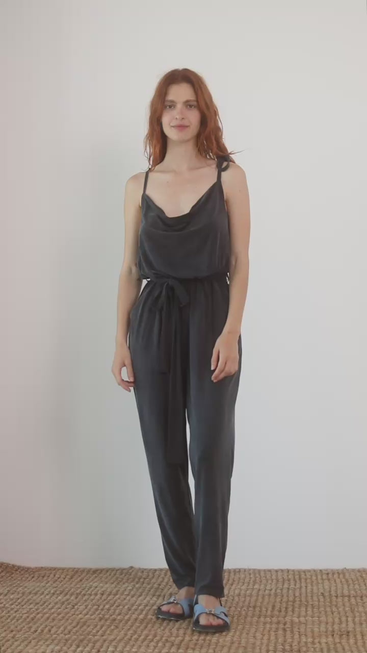 Cupro Slip Jumpsuit with Belt in Slate Black worn by model, showcasing relaxed elegance and versatility.