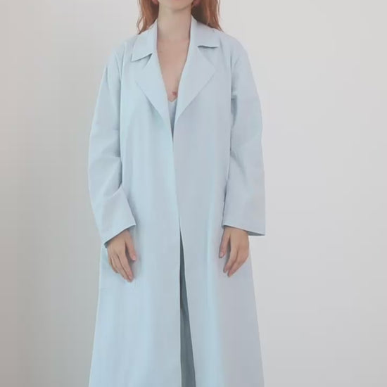 Lightweight Organic Cotton Trench Coat in Pale Blue displayed on a model, showcasing its relaxed silhouette and soft fabric.