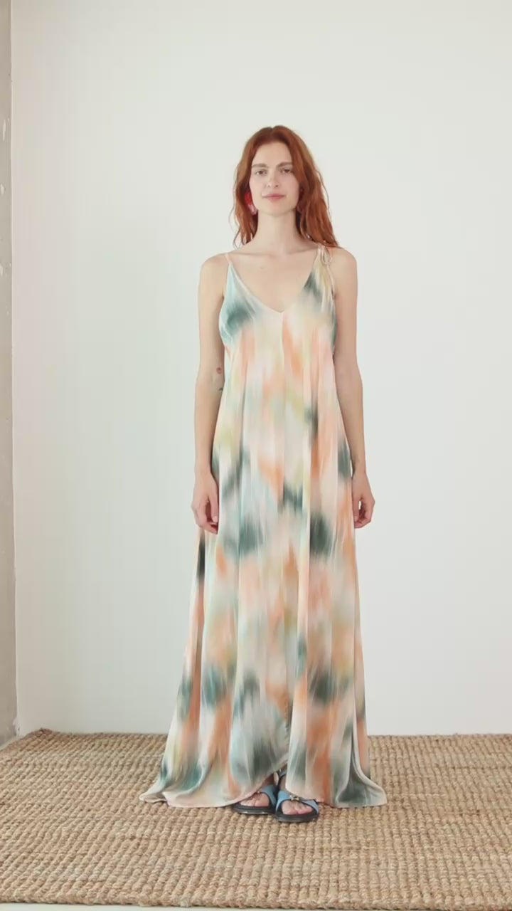 Model wearing a Printed Ecovero Viscose Maxi Dress in soft colors, showcasing adjustable straps and a flowing design.