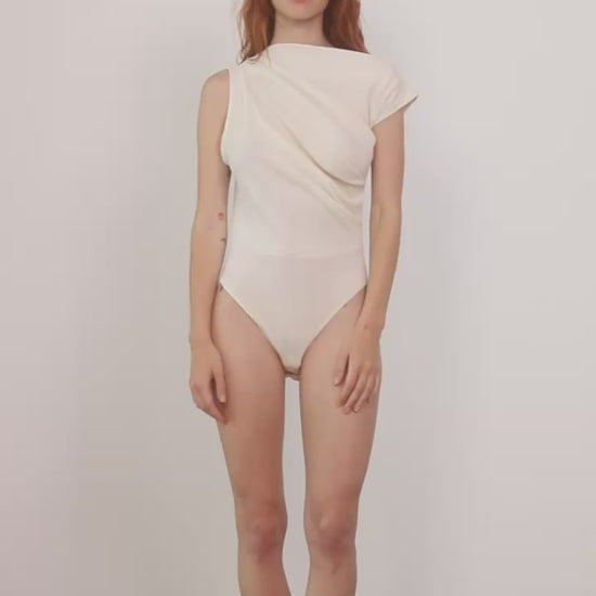 Model wearing the Banana Pineapple Drape Neckline Bodysuit in Ecru, showcasing its elegant draped design.