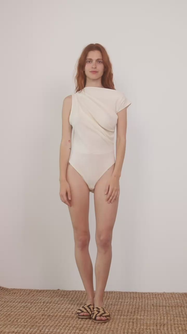 Model wearing the Banana Pineapple Drape Neckline Bodysuit in Ecru, showcasing its elegant draped design.