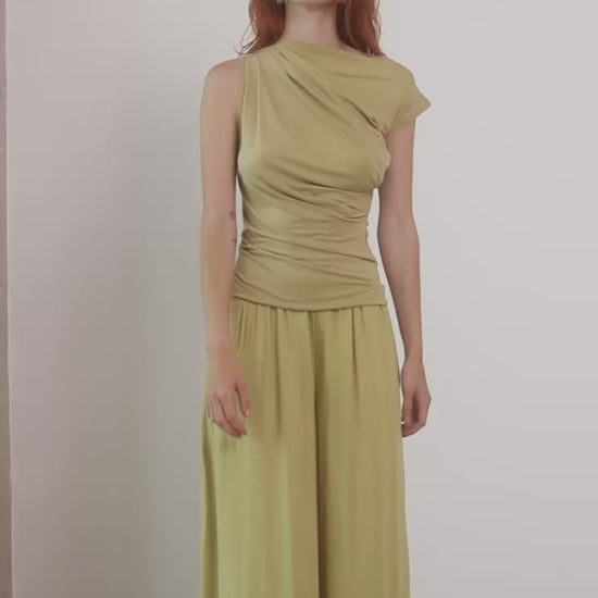 Wide Ecovero Trousers in Soft Olive displayed on model, showcasing elegant silhouette and sustainable fabric.